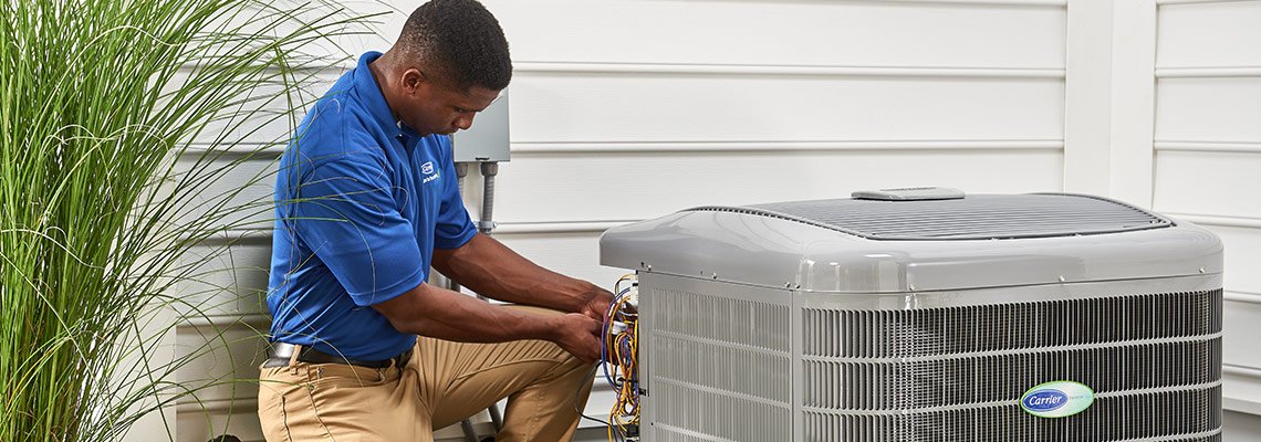 HVAC serviceman repairing A/C unit